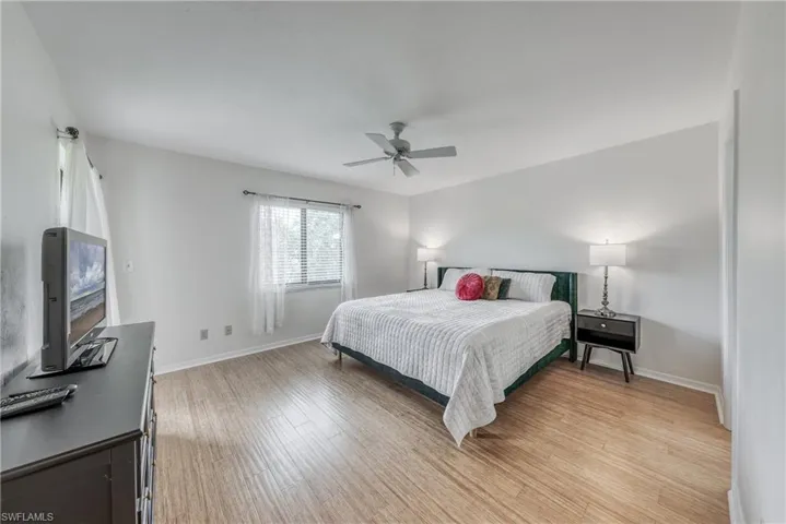 Bedroom featuring ceiling fan and light hardwood / wood-style floors