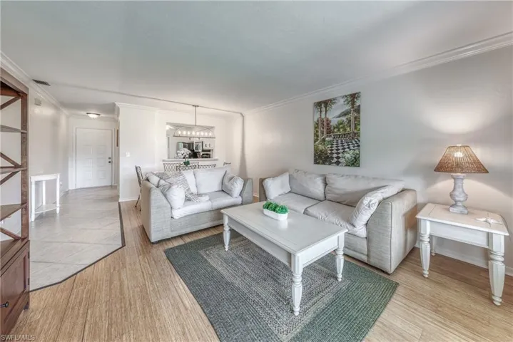 Living room featuring ornamental molding and hardwood / wood-style floors