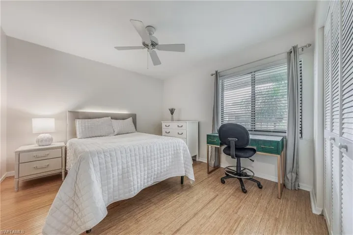 Bedroom with ceiling fan, a closet, and light hardwood / wood-style flooring