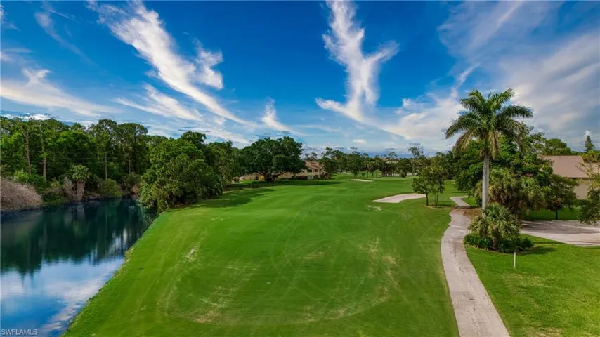 Surrounding community featuring a lawn and a water view