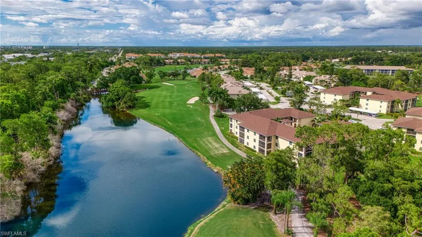 Birds eye view of property with a water view