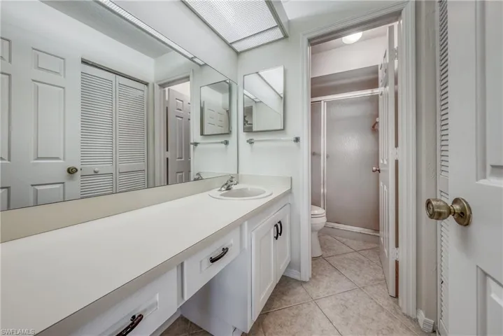 Bathroom featuring tile flooring, oversized vanity, and toilet