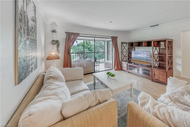 Living room featuring ornamental molding and hardwood / wood-style floors