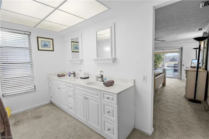 PPrivate primary bath off the primary bedroom has spacious double sink and vanity, large walk-in showewr and walk-in closet.