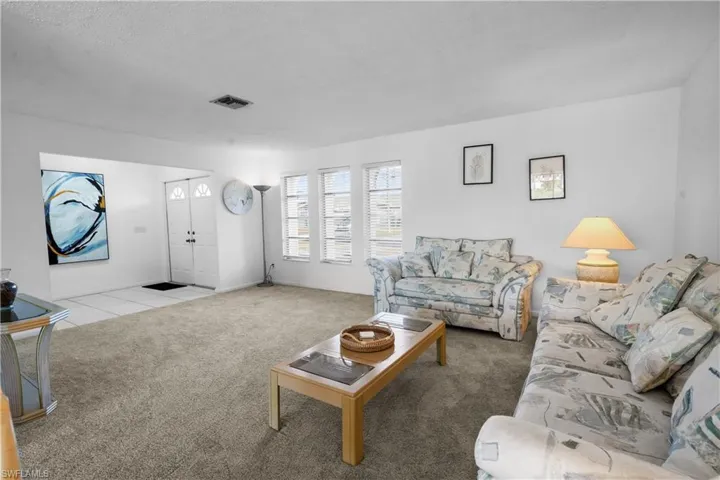 Double door entry opens to the foyer and living room has wonderful natural lighting.