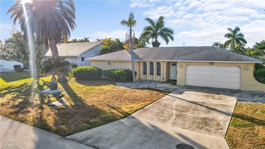 Ranch-style concrete block construction, with stucco finish, newer roof and attached oversized two car garage.