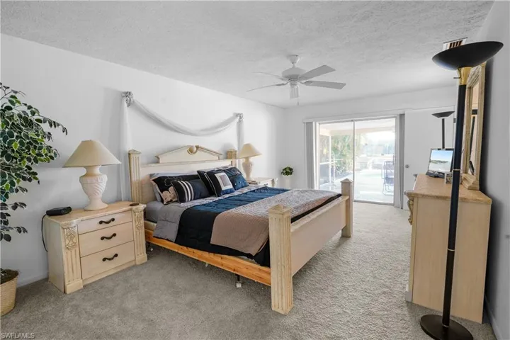 Spacious main bedroom suite features patio doors to covered lahai and pool area.