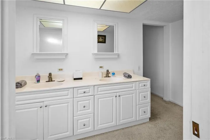 Primay private bathroom featuring a double vanity with two drawers banks.