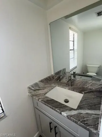 Bathroom featuring vanity and toilet
