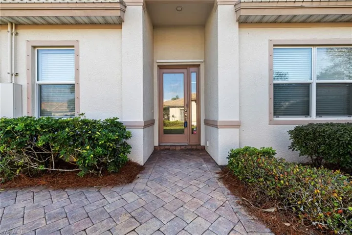 View of exterior entry featuring stucco siding