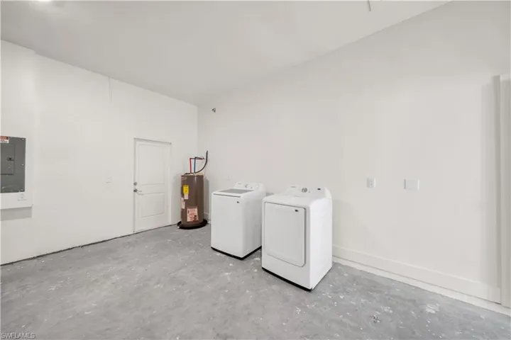 Utility area featuring concrete flooring and white painted walls