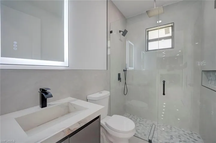 Bathroom with vanity and a shower stall