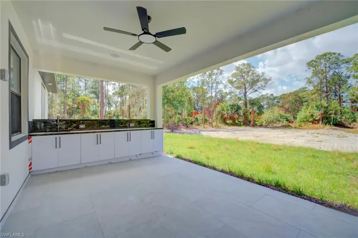 View of patio / terrace with a ceiling fan and a sink
