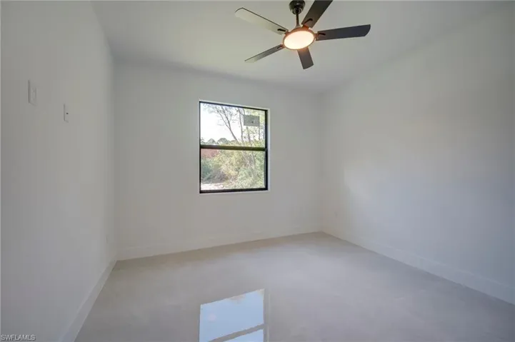 Unfurnished room featuring baseboards and a ceiling fan
