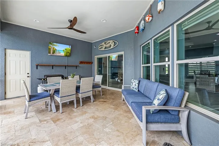View of patio featuring a ceiling fan and outdoor dining area