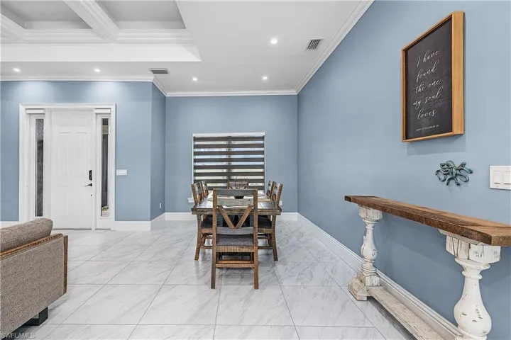 Dining area featuring recessed lighting, crown molding, and tiled flooring