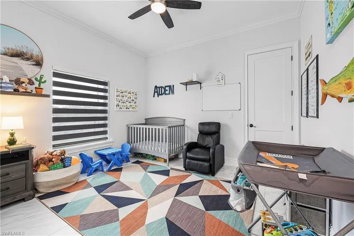 Bedroom with crown molding and a ceiling fan