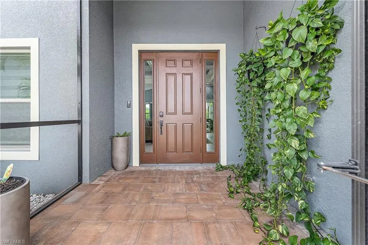 Doorway to property with stucco siding