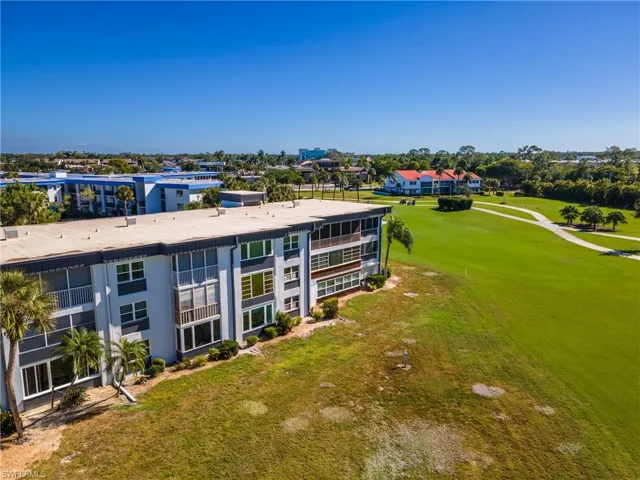 Aerial view of apartment complex / building and a golf club
