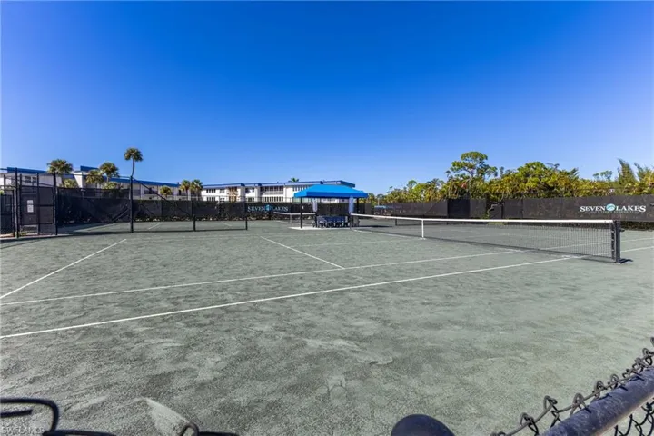 View of tennis court featuring community basketball court