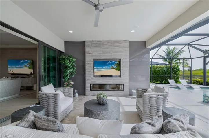 View of patio with an outdoor living space, a sunroom, a ceiling fan, and a lanai