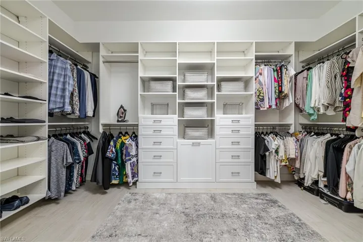 Spacious closet with light wood-style flooring