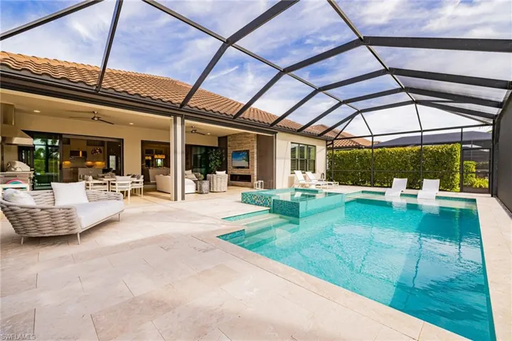 View of pool featuring a sunroom, a lanai, an outdoor hangout area, and a patio area