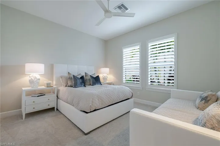 Bedroom featuring light carpet and ceiling fan