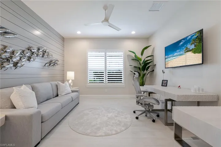 Office area featuring a ceiling fan, light wood-style floors, and recessed lighting