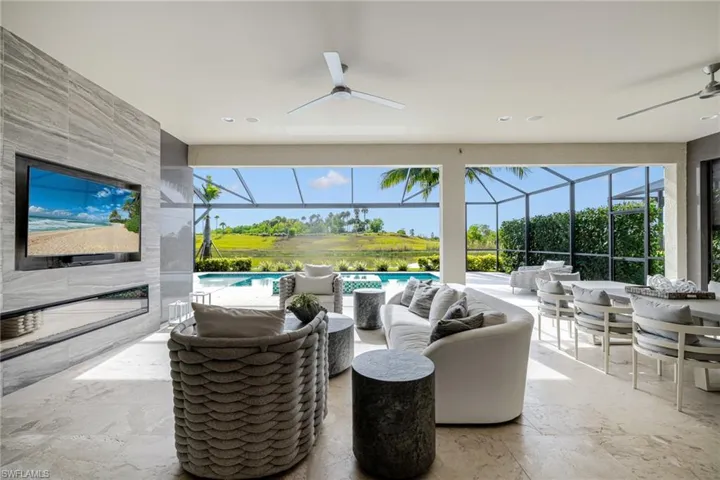View of patio / terrace featuring ceiling fan, a sunroom, outdoor lounge area, and glass enclosure