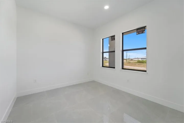 Spare room with recessed lighting and baseboards