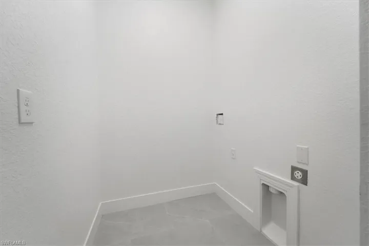 Laundry room with laundry area, marble finish floor, baseboards, and hookup for an electric dryer