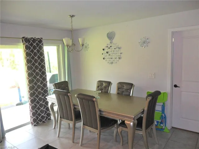 Dining space featuring a chandelier and light tile patterned floors