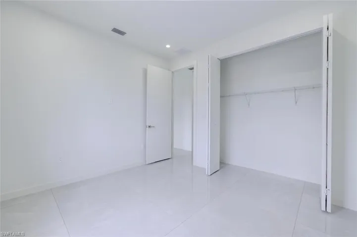 Unfurnished bedroom featuring light tile patterned floors, a closet, and recessed lighting