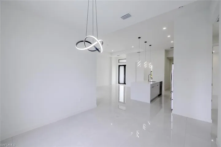 Spare room with light tile patterned floors and recessed lighting