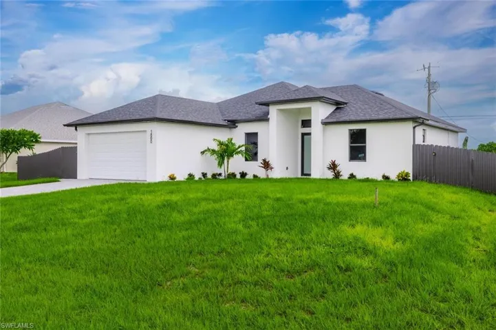 View of front of house featuring concrete driveway, roof with shingles, an attached garage, and stucco siding