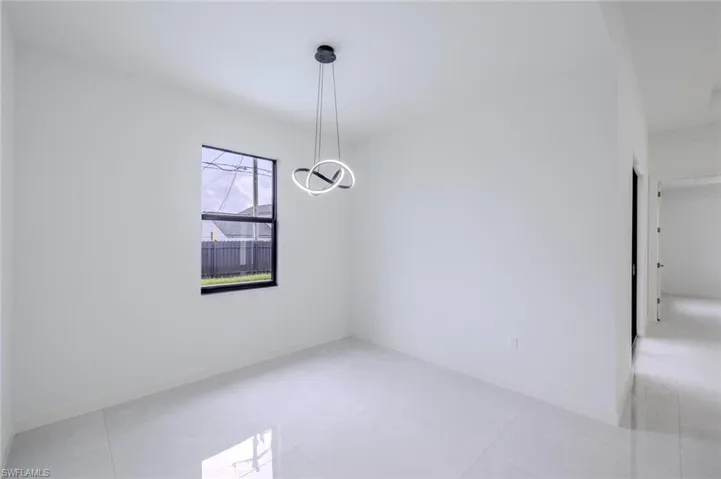 Empty room featuring light tile patterned floors