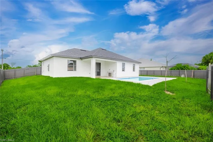 Back of house featuring a patio, a fenced backyard, and stucco siding