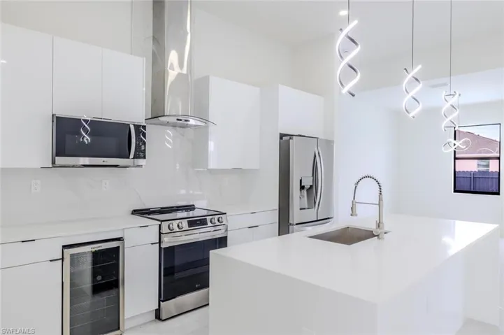 Kitchen featuring pendant lighting, white cabinets, and modern cabinets