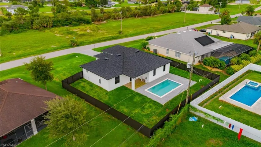 Aerial perspective of suburban area featuring a pool