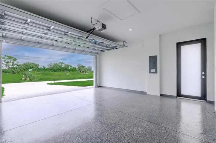 Garage with electric panel and a garage door opener