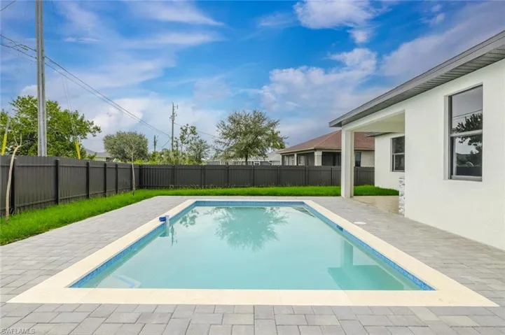 View of swimming pool featuring a patio area and a fenced backyard