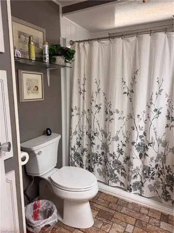 Bathroom with toilet, walk-in shower