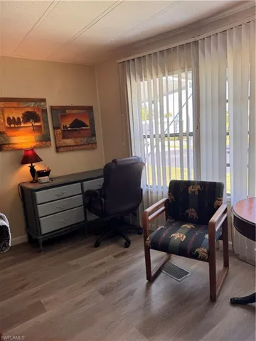 Desk in living room, good lighting, laminate floors
