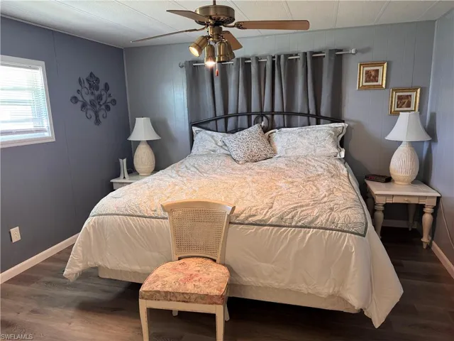 Master bedroom, king bed, access to backyard deck, panel walls, laminate flooring
