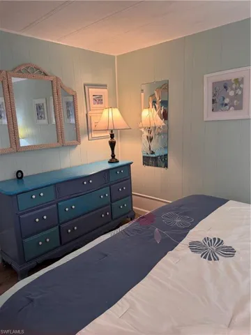 Guest bedroom featuring paneled walls, king bed