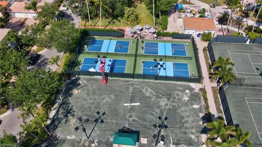 Aerial perspective showcasing multi-sport court facilities, including four blue and green pickleball courts, and two green tennis courts