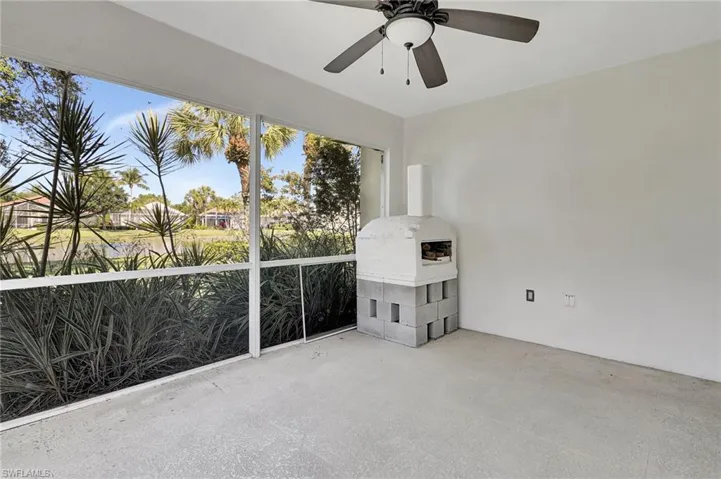 Screened patio featuring a built-in outdoor oven on a concrete block base