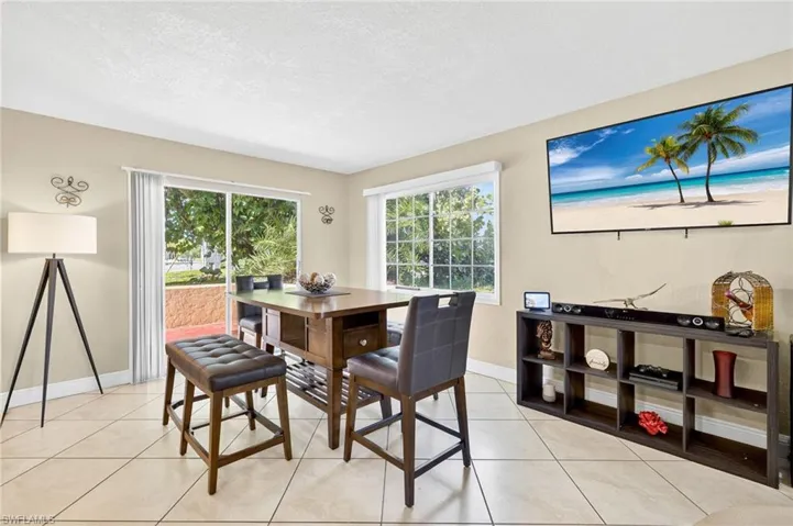 Dining area featuring a textured ceiling and light tile patterned floors