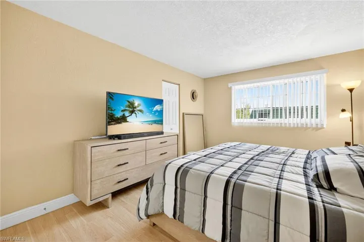 Bedroom featuring light wood-style floors and a textured ceiling